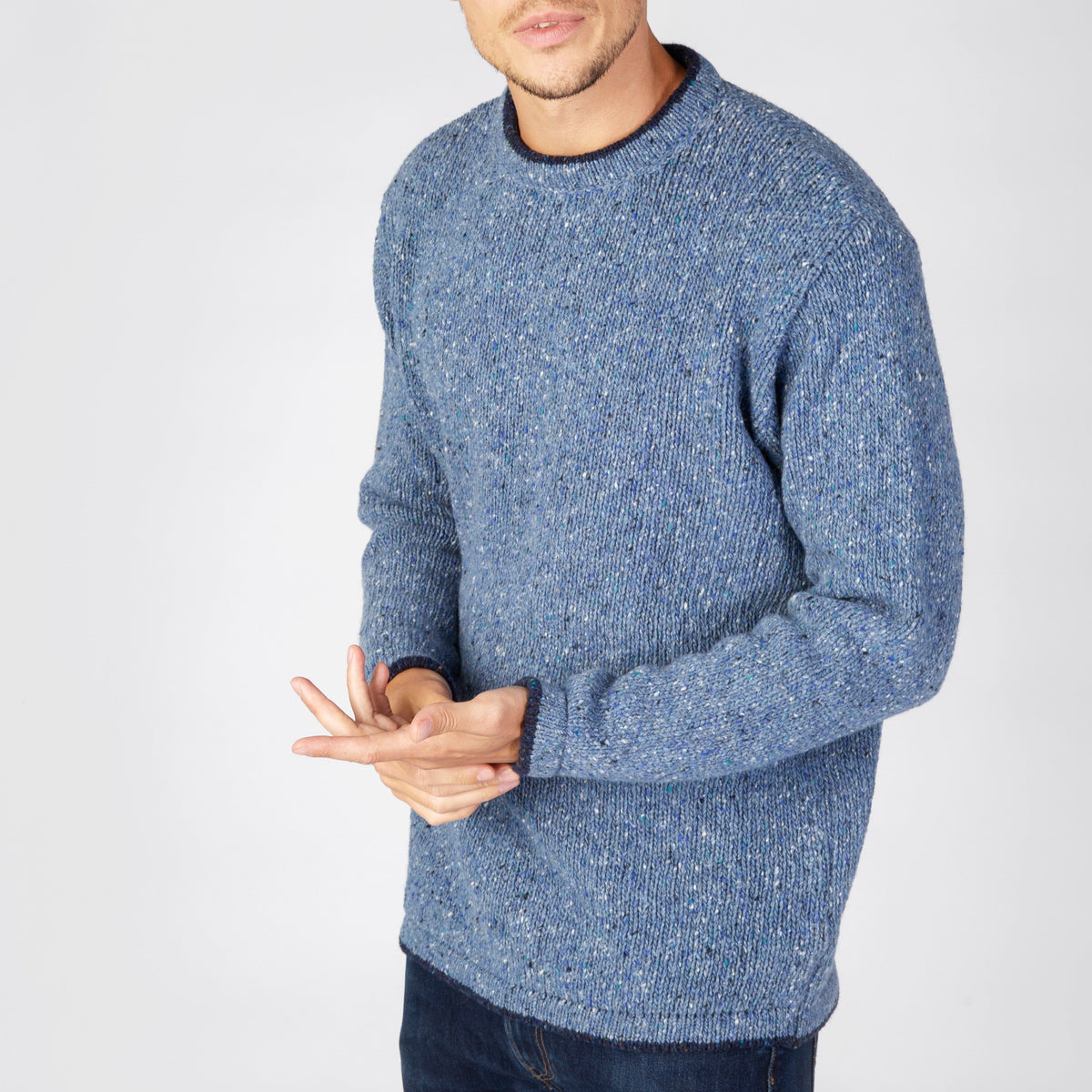 Man wearing a blue sweater on a white background